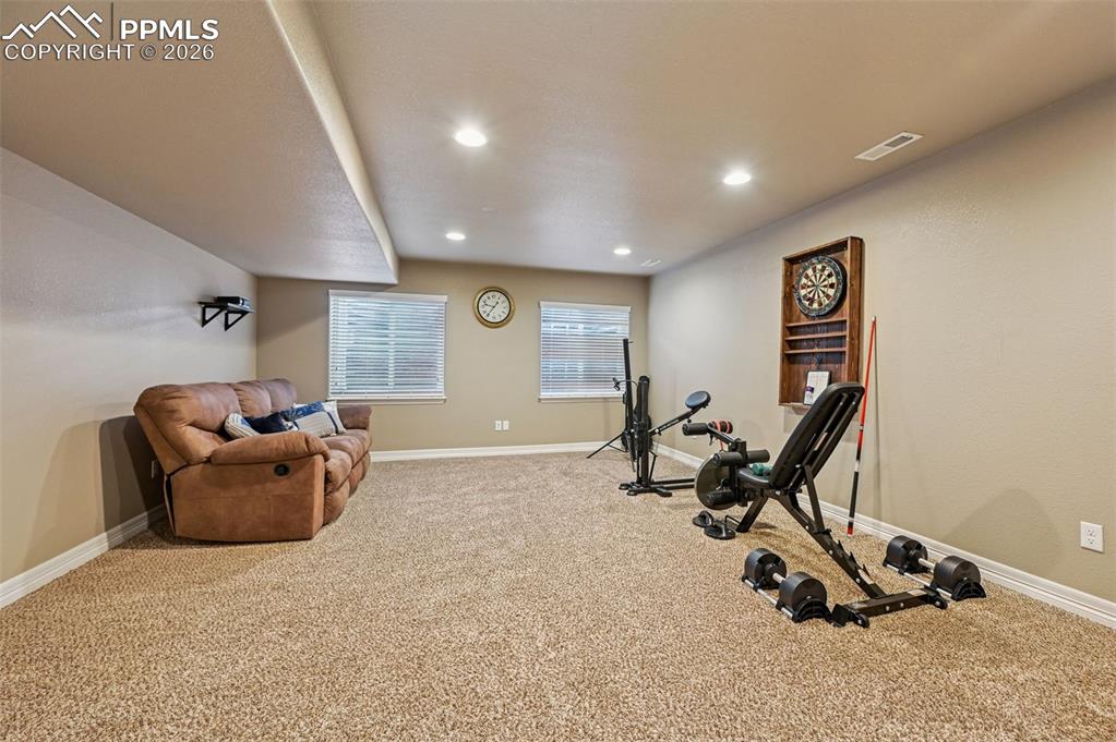 Exercise area featuring light colored carpet and recessed lighting