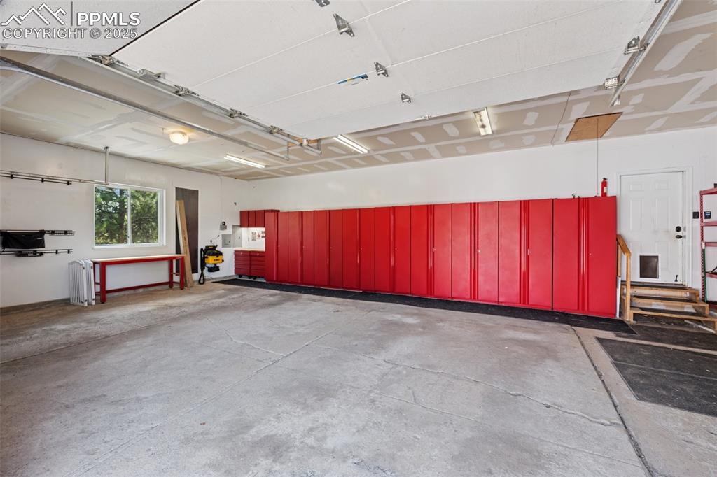 Cabinets and Matching Workbench in 3 Car Attached Garage.  Included!!