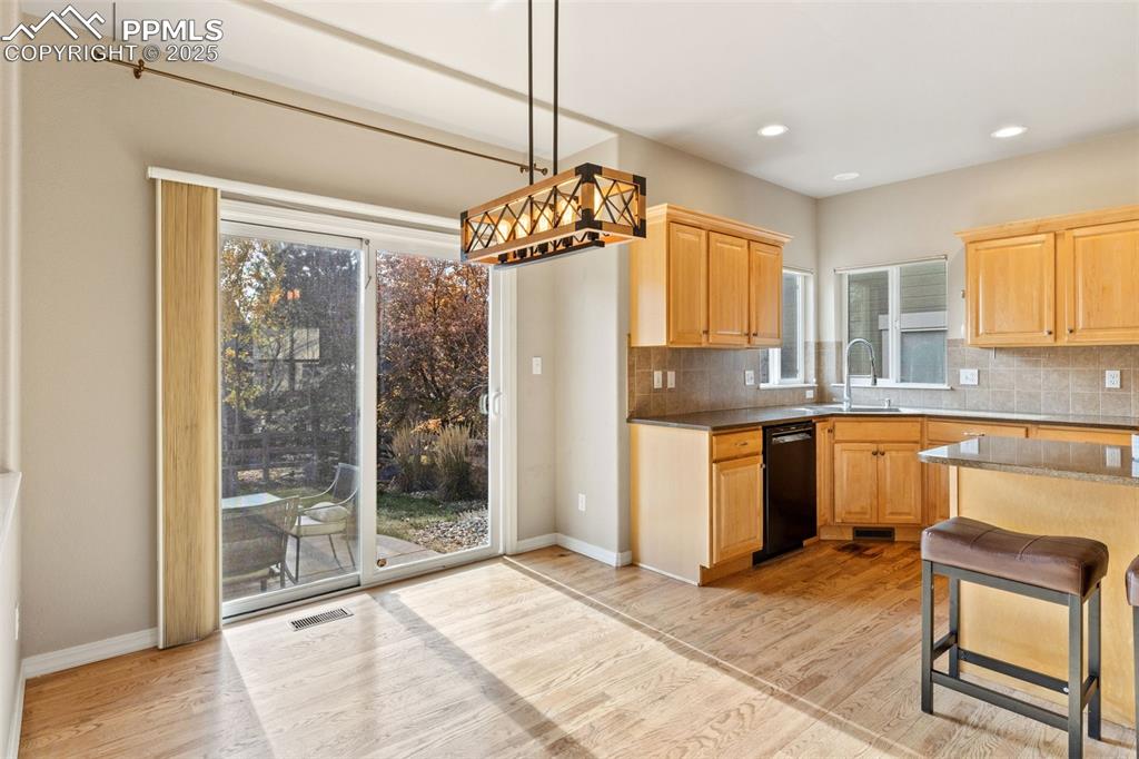 The informal dining area leads to the beautiful outdoor space. 