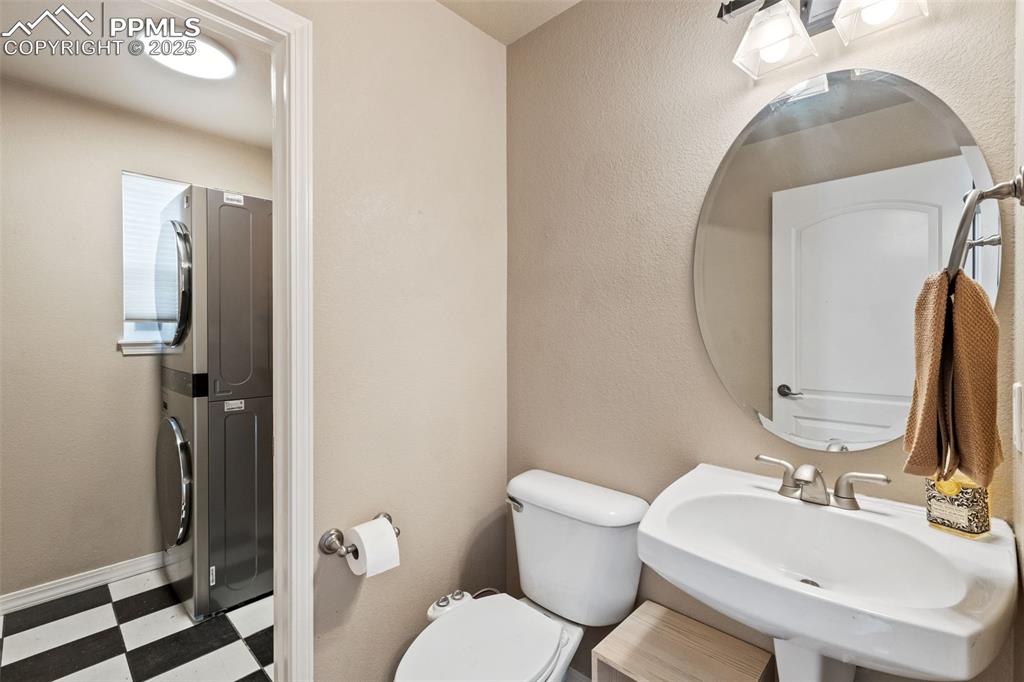 The powder room and adjacent laundry area are at the garage entry. The newer washer and dryer are included!!