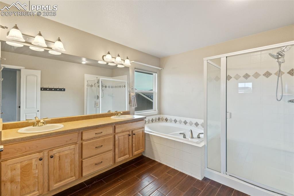 The primary bath features a large double vanity, soaking tub and tiled walk-in shower.