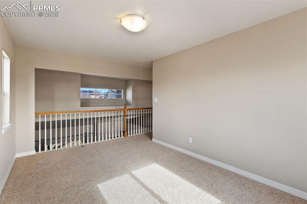 Upper level loft overlooks the entry and dining room. How will you use this bonus space... Office, crafting, TV room, playroom? The possibilities await.