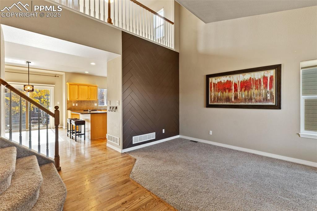 Vaulted ceilings and a view of the open living area greet you as you enter. This carpeted room can be your formal living or dining room, you choose.