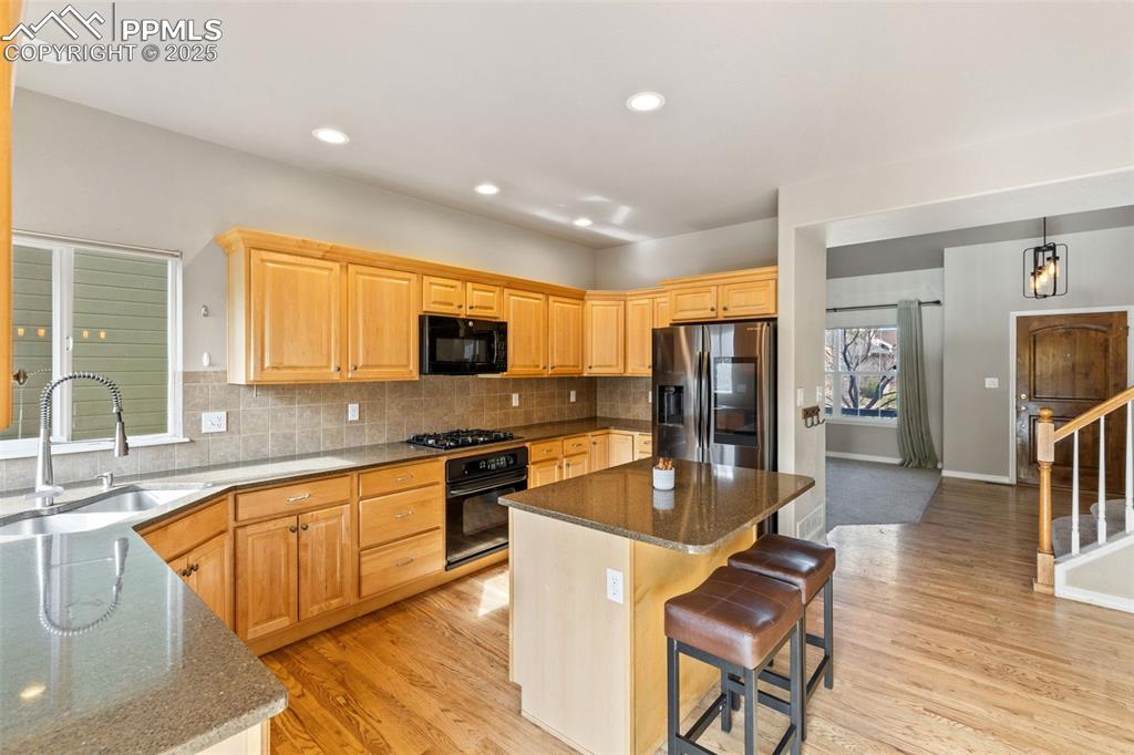 All of the cooks in the family will enjoy this well-appointed kitchen with granite counters and island.