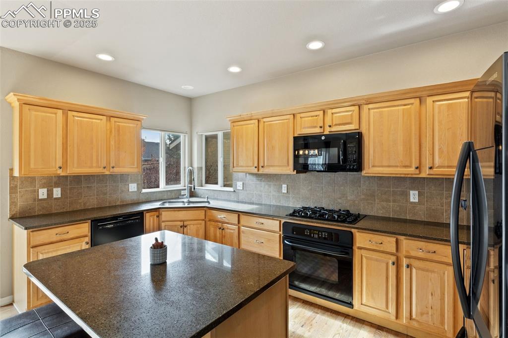 This wonderful kitchen includes a tile backsplash and gas cooktop. All appliances convey.