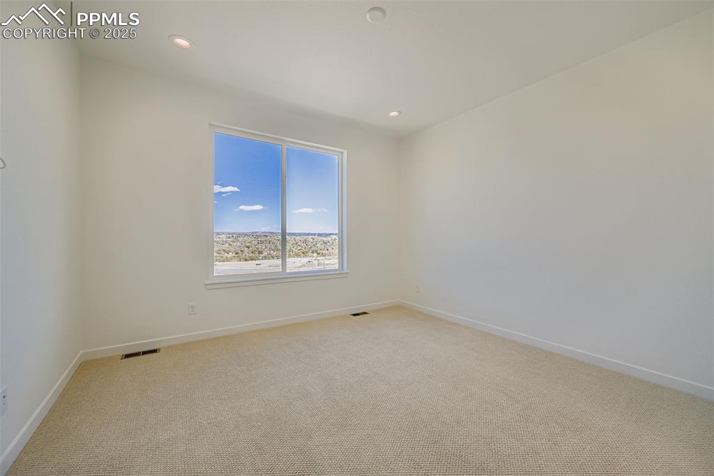 Unfurnished room with light carpet and recessed lighting