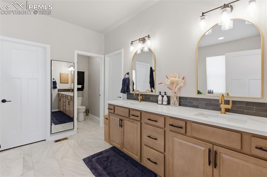 There Are 2 Walk-In Closets & Quartz Countertops In Primary Bah