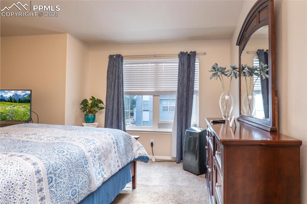 Upper primary bedroom has carpet and backs to open space.