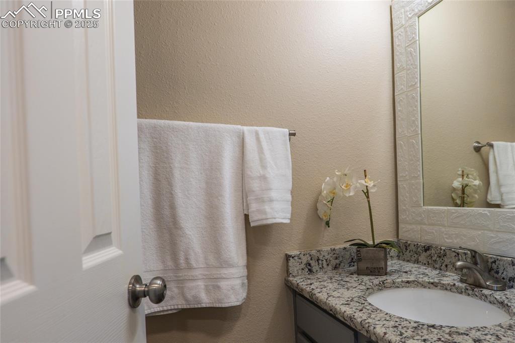 Main level 1/2 bath to include granite countertop and LVP flooring.