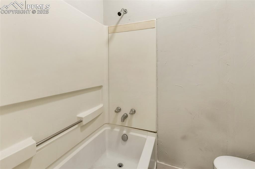 Full bathroom featuring shower / bathtub combination and toilet