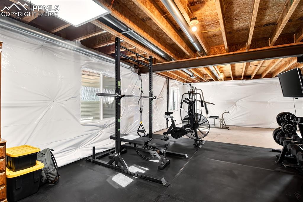 Unfinished basement being used as workout area