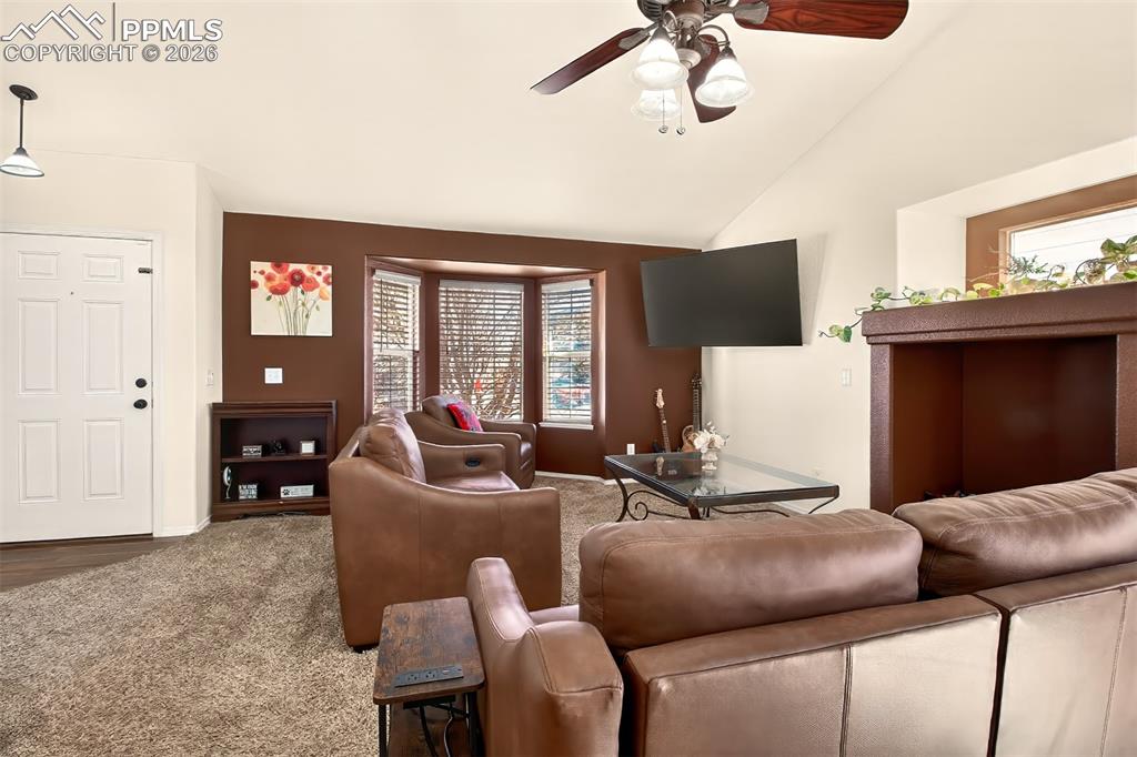 Living room with gas fireplace and plenty of natural light 