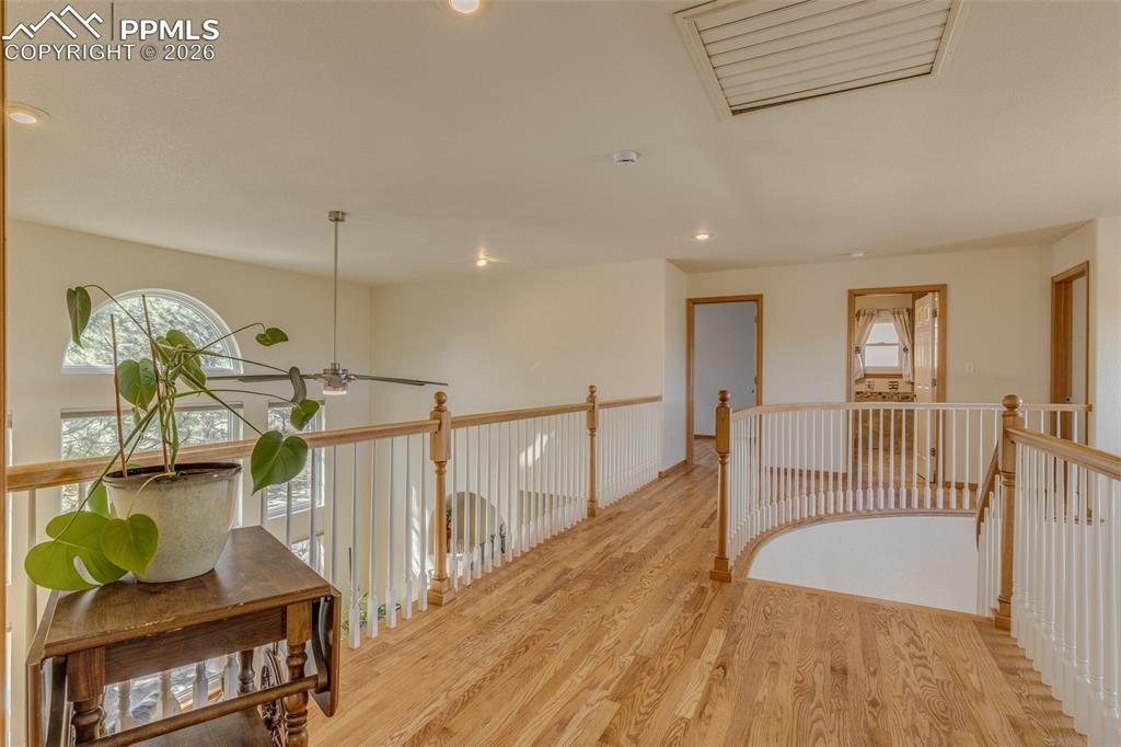 Corridor featuring cooling unit, recessed lighting, light wood-style floors, and an upstairs landing