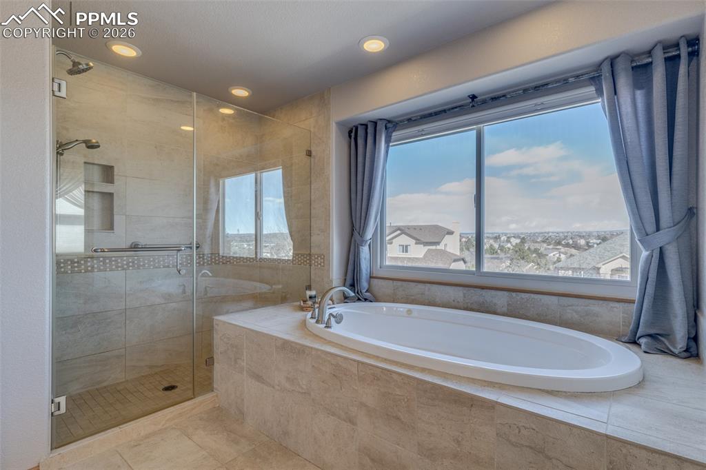 Full bath featuring a shower stall, recessed lighting, a garden tub, and light tile patterned floors