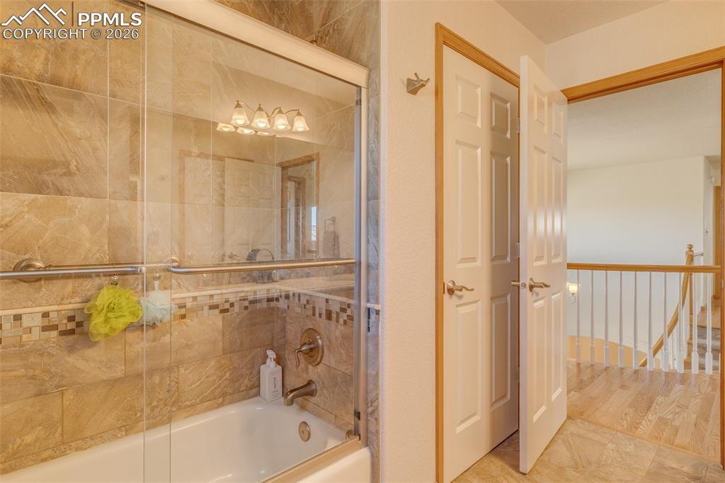 Full bath with shower / bath combination with glass door