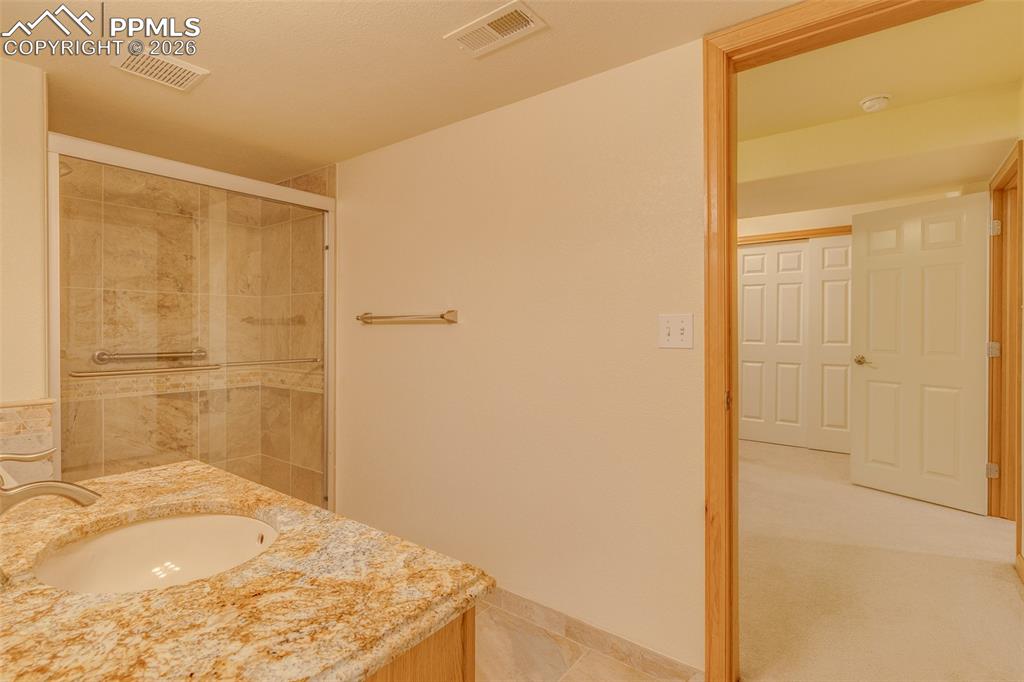 Full bath featuring vanity and a stall shower