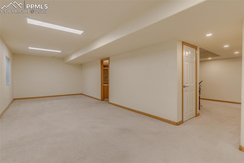 Finished below grade area with light carpet and recessed lighting