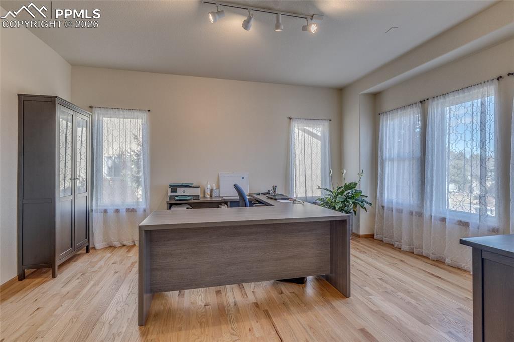 Office area featuring rail lighting