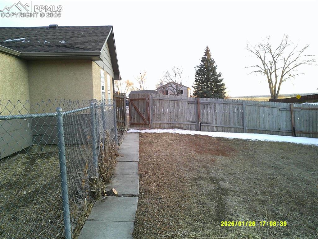 Fenced backyard with a gate