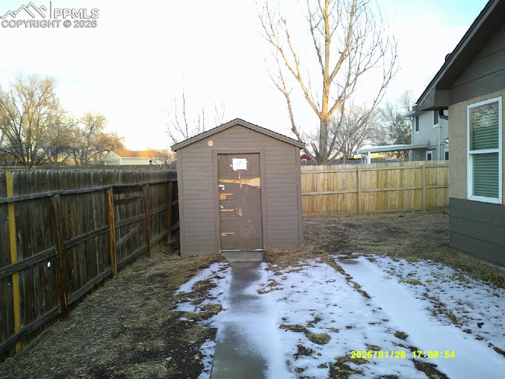 View of shed with a fenced backyard