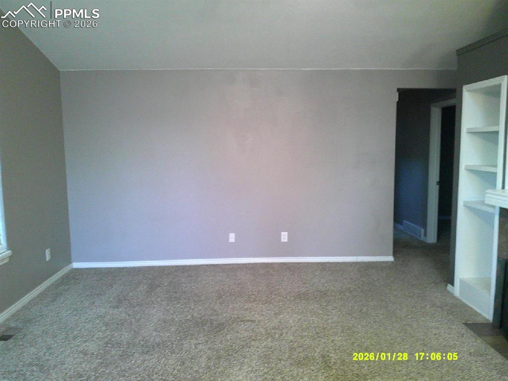 Unfurnished bedroom with carpet flooring
