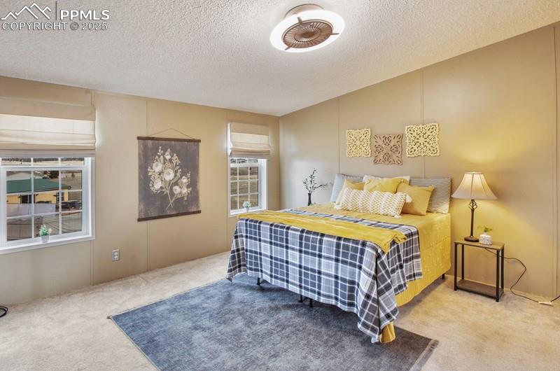Carpeted bedroom featuring a textured ceiling