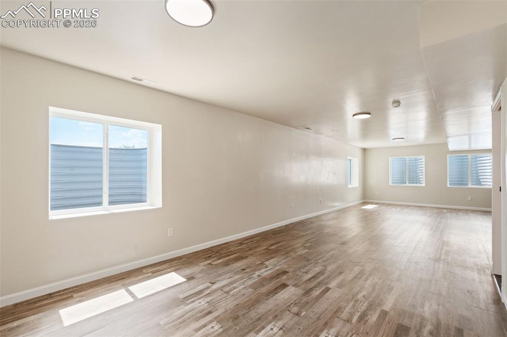 Empty room with baseboards and light wood-style floors