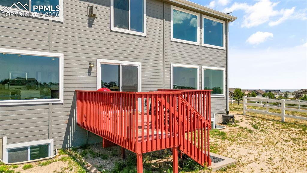 Rear view of house featuring a wooden deck