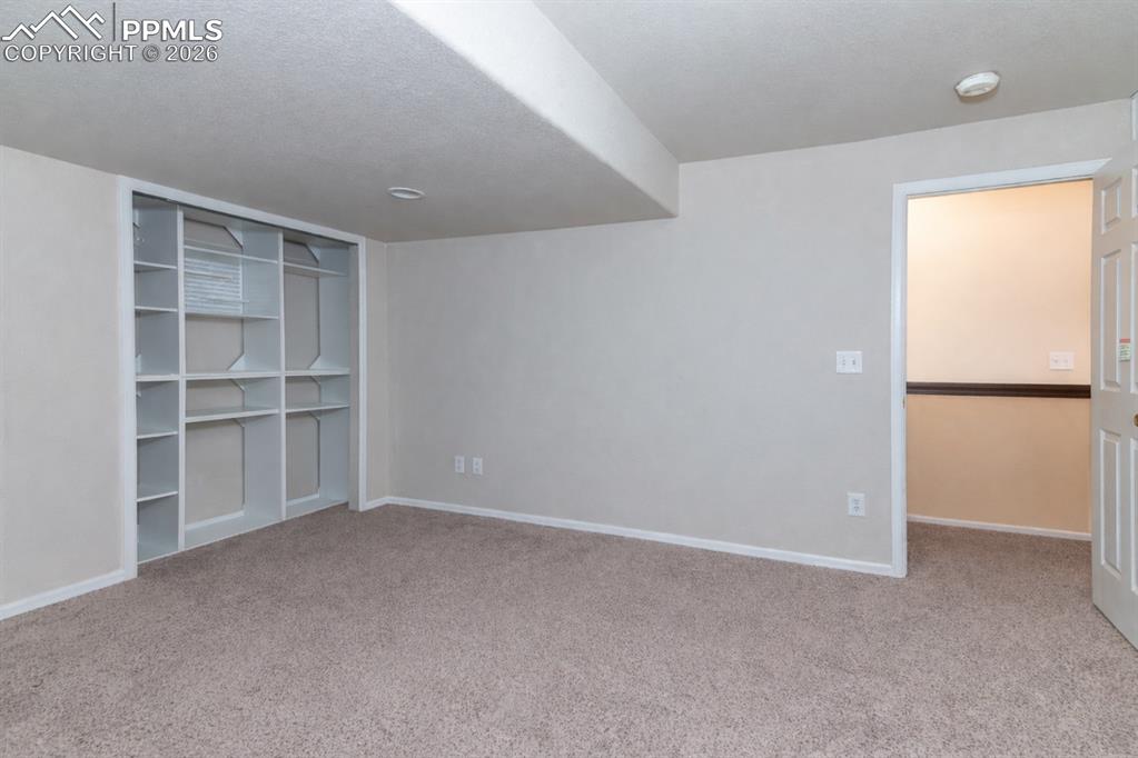 Unfurnished bedroom featuring light carpet and a closet