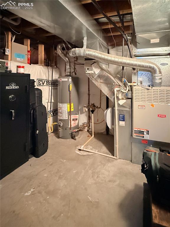 Utility room featuring gas water heater, forced air heating/AC unit, and crawl-space access