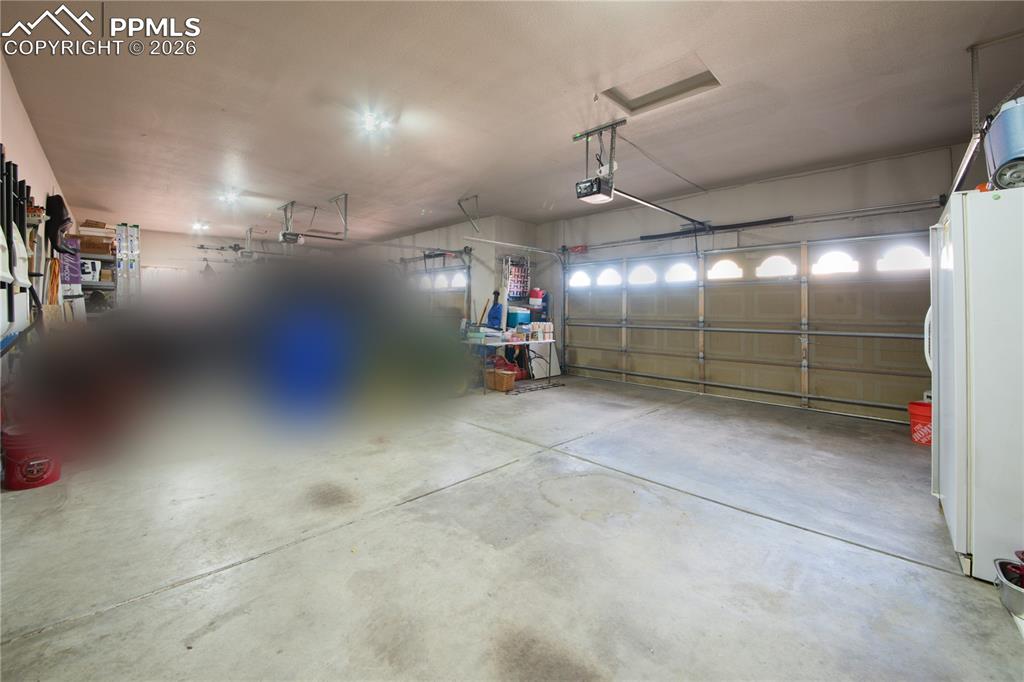 Garage featuring freestanding refrigerator