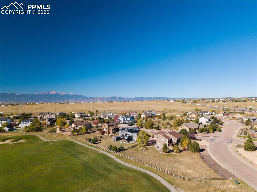 Aerial view of home looking from the east featuring mountains and Antler Creek Golf Course