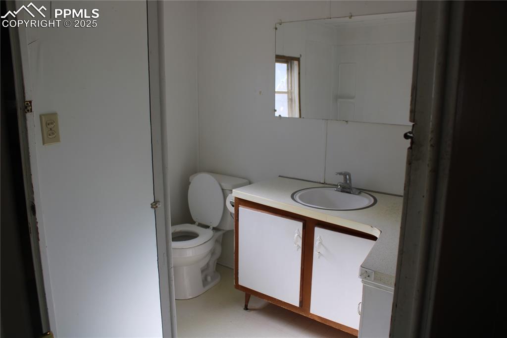 Half bath with vanity and toilet
