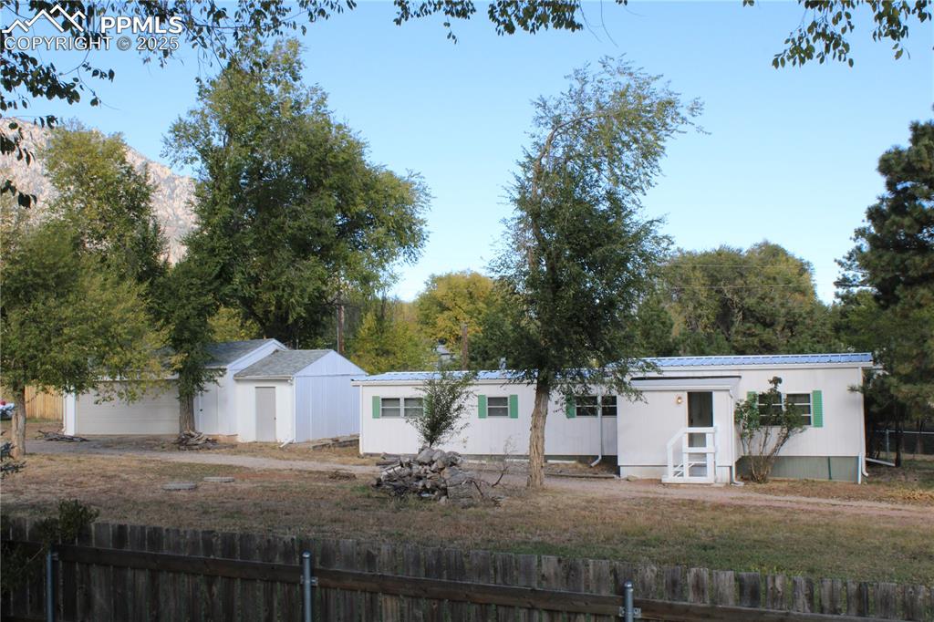 Back of house featuring a metal roof