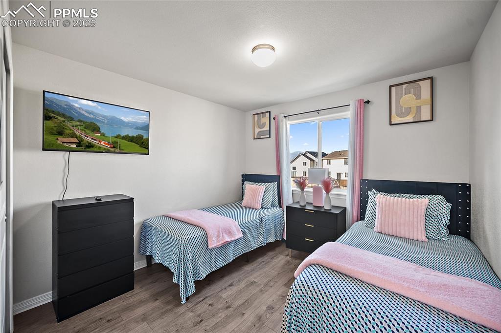 Bedroom featuring wood finished floors and baseboards