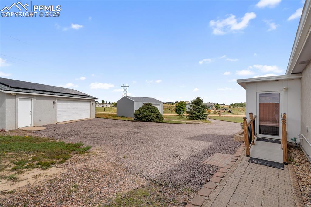 Detached 2-car garage with solar and extra workshop space.
