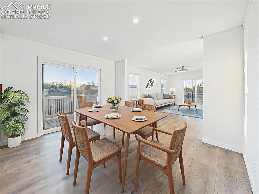 Virtually Staged Enjoy meals by the sliding glass door in this light-filled dining area, which opens into a second living space perfect for lounging or play.