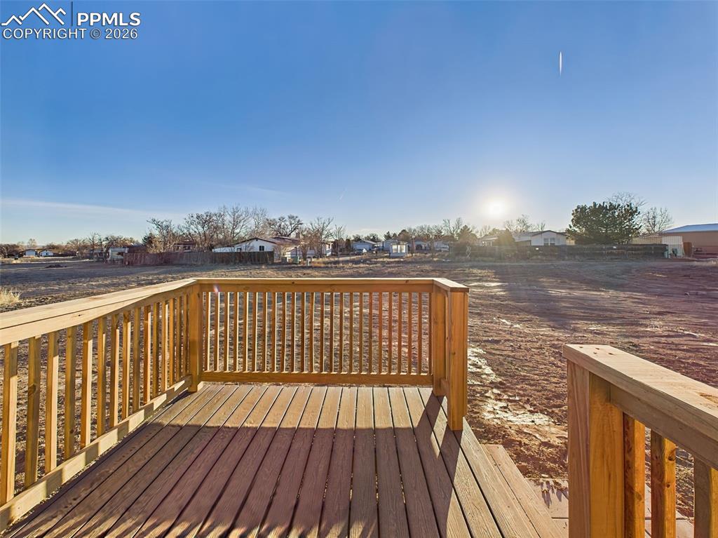 Capture the sunrise from the side deck off dining room, where open views create a peaceful setting for outdoor enjoyment.