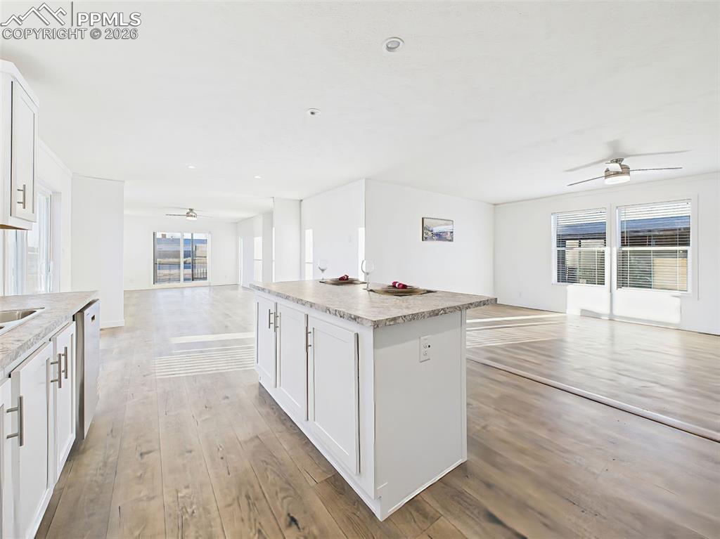 The open-concept design provides clear sightlines from the kitchen into both front and rear living spaces, creating a bright and unified main living area.