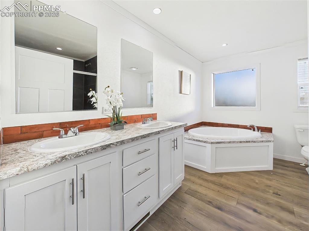 Featuring a 5-piece design, this spacious bath includes a dual-sink vanity, large soaking tub, and separate shower for added functionality.