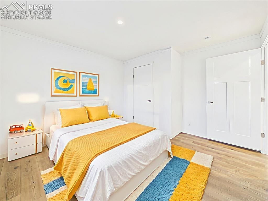 Virtually Staged Spacious third bedroom with large closet and staged for comfort with sunny, playful accents.