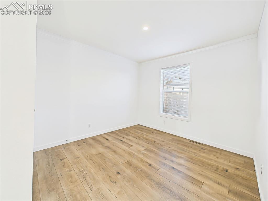 A clean, neutral space ready to accommodate a guest room, nursery, or office.
