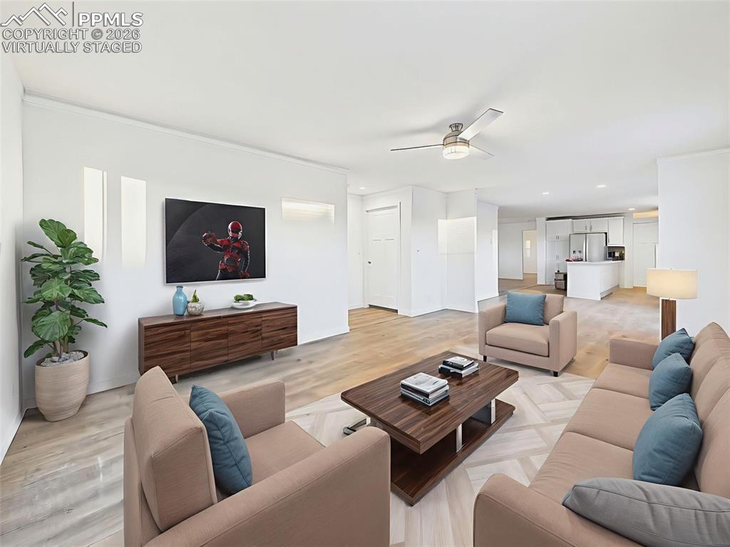 Virtually Staged A second living space offers flexibility for a media room, lounge, or home office setup, with modern lighting and a view into the heart of the home.