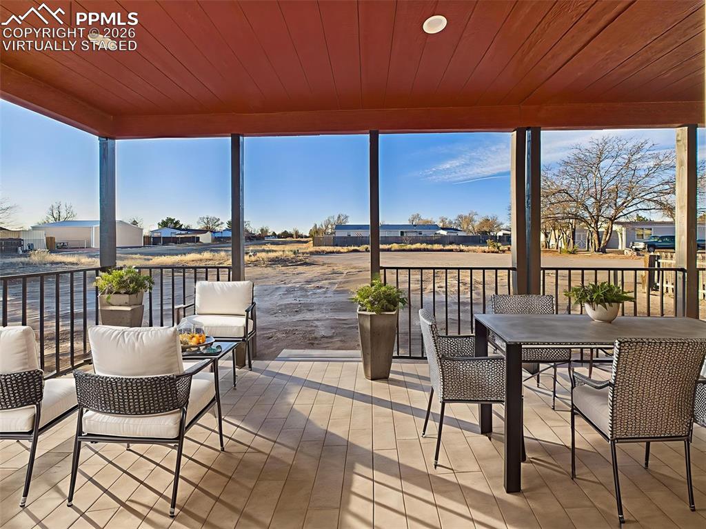 Virtually Staged Enjoy outdoor living year-round on this spacious covered patio, featuring tile-look flooring, recessed lighting, and ample space for both dining and lounging.