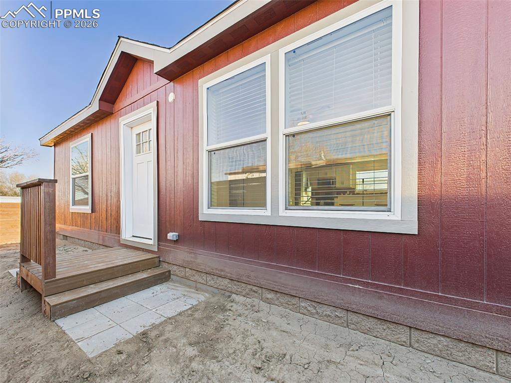 Front door porch located in fenced area