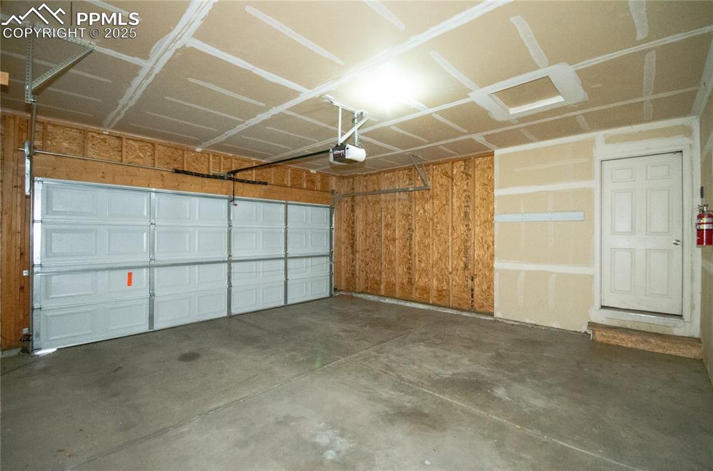 Spacious 2-car Garage featuring a garage door opener