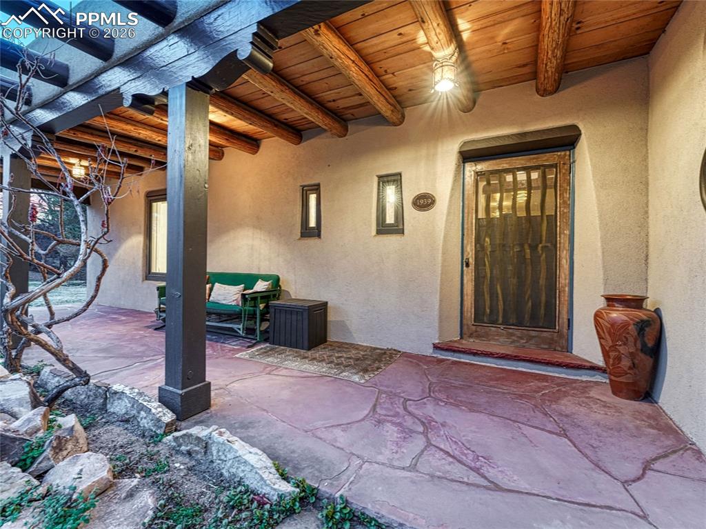 Main entrance with original beamed ceiling, door and light fixtures.