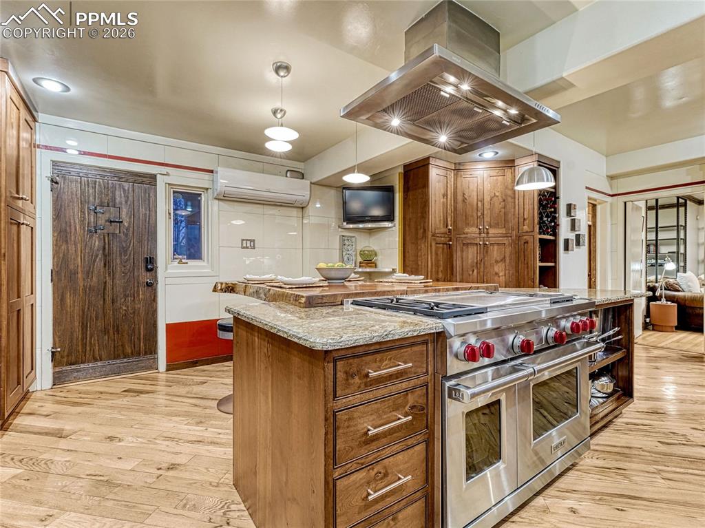 Viking range, custom wood seating area, original Vitrolite wall tile.