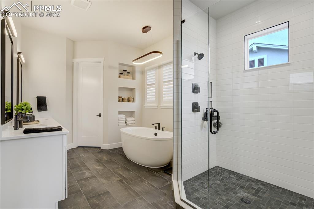 Master bath featuring large shower w/seat, freestanding soaking tub, double vanity, and separate water closet