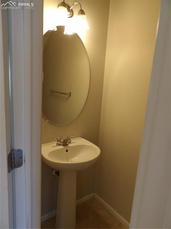Bathroom with tile patterned flooring and baseboards
